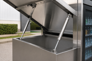 Stainless steel gas springs for outdoor vending holding a weatherproof vending machine door open