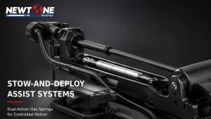 Dual-action gas spring supporting deployment and controlled return on a stow-and-deploy mechanism.